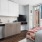 a kitchen with a bed and a television