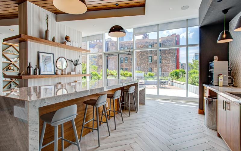 a kitchen with stools and a bar